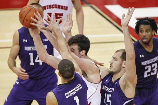 Northwestern's Drew Crawford (1) and Nikola Cerina (45) trap Wisconsin's Frank Kaminsky during the second half of an NCAA college basketball game Wednesday, Jan. 29, 2014, in Madison, Wis. Northwestern upset Wisconsin, 65-56. (AP Photo/Andy Manis)