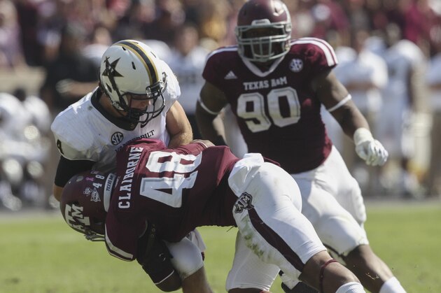 COLLEGE STATION, TX - OCTOBER 26:  Darian Claiborne #48 of the Texas A&M Aggies lays a hard hit on Patton Robinette #4 of the Vanderbilt Commodores at Kyle Field on October 26, 2013 in College Station, Texas.  (Photo by Bob Levey/Getty Images)