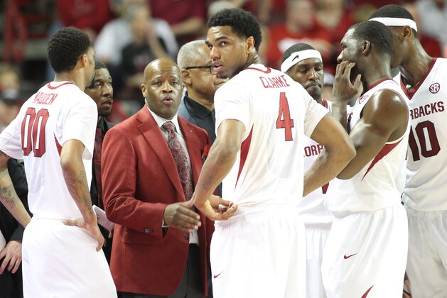 Feb 15, 2014; Fayetteville, AR, USA; Arkansas Razorbacks head coach Mike Anderson talks to his players including forward Coty Clarke (4) during the game against the Louisiana State Tigers at Bud Walton Arena. Arkansas defeated LSU 81-70. Mandatory Credit: Nelson Chenault-USA TODAY Sports