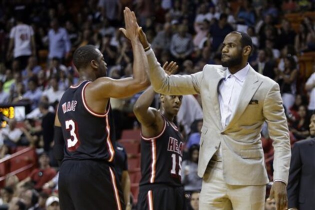 Miami Heat's LeBron James, right, high-fives Dwyane Wade (3) during a time out in the second half of an NBA basketball game against the Chicago Bulls, Sunday, Feb. 23, 2014, in Miami. The Heat defeated the Bulls 93-79. (AP Photo/Lynne Sladky) Miami Heat's LeBron James, right, high-fives Dwyane Wade (3) during a time out in the second half of an NBA basketball game against the Chicago Bulls, Sunday, Feb. 23, 2014, in Miami. The Heat defeated the Bulls 93-79. (AP Photo/Lynne Sladky)