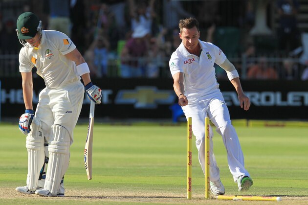 South Africa's bowler Dale Steyn, right, points at fallen stumps after after bowling Australia's batsman Brad Haddin, left, for 1 run on the fourth day of their 2nd cricket test match at St George's Park in Port Elizabeth, South Africa, Sunday, Feb. 23, 2014. (AP Photo/ Themba Hadebe)