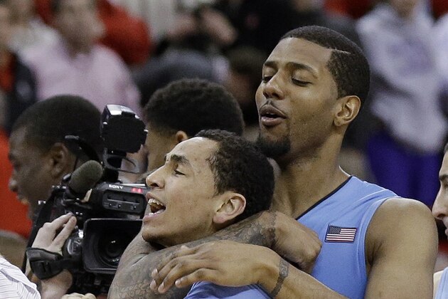 North Carolina's Marcus Paige and Leslie McDonald, right, celebrate Paige's shot in overtime to beat North Carolina State 85-84 in an NCAA college basketball game in Raleigh, N.C., Wednesday, Feb. 26, 2014. (AP Photo/Gerry Broome)