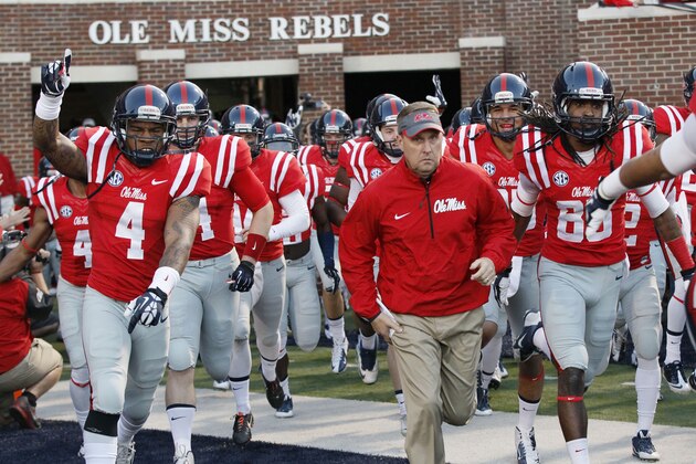 Mississippi football coach Hugh Freeze leads his team to the field prior to their NCAA college football game against No. 6 LSU at Vaught-Hemingway Stadium in Oxford, Miss., Saturday, Oct. 19, 2013. Mississippi won 27-24. (AP Photo/Rogelio V. Solis)