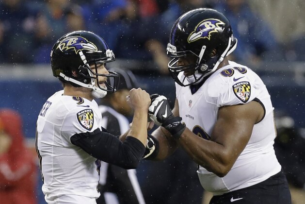 Baltimore Ravens kicker Justin Tucker (9) celebrates his 52-yard field goal with Eugene Monroe (60) during the first half of an NFL football game against the Chicago Bears, Sunday, Nov. 17, 2013, in Chicago. (AP Photo/Nam Y. Huh)