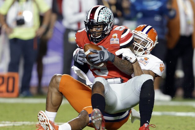 Ohio State quarterback Braxton Miller is brought down by Clemson defensive end Vic Beasley during the first half of the Orange Bowl NCAA college football game, Friday, Jan. 3, 2014, in Miami Gardens, Fla. (AP Photo/Lynne Sladky)