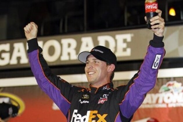 Denny Hamlin celebrates in Victory Lane after winning the second of two NASCAR Sprint Cup series qualifying auto races at Daytona International Speedway in Daytona Beach, Fla., Thursday, Feb. 20, 2014. (AP Photo/Terry Renna)