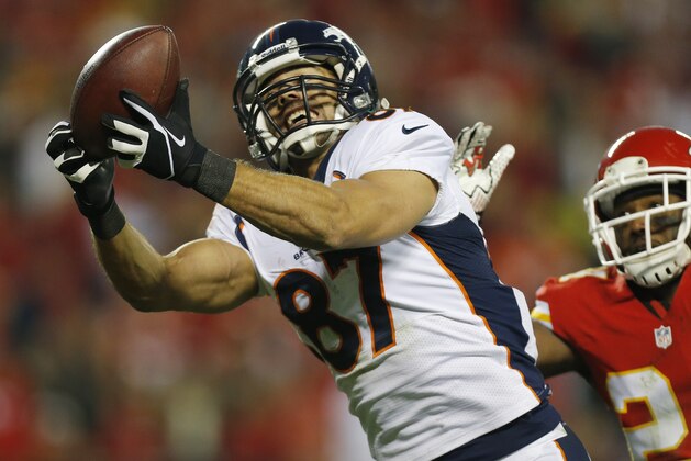 Denver Broncos wide receiver Eric Decker (87) makes a touchdown reception against Kansas City Chiefs cornerback Brandon Flowers (24) during the second half of an NFL football game, Sunday, Dec. 1, 2013, in Kansas City, Mo. (AP Photo/Ed Zurga)