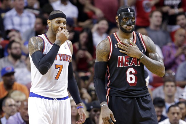 New York Knicks small forward Carmelo Anthony (7) and Miami Heat small forward LeBron James (6) talk during the second half of an NBA basketball game in Miami, Thursday, Feb. 27, 2014. The Heat won 108-82. (AP Photo/Alan Diaz)