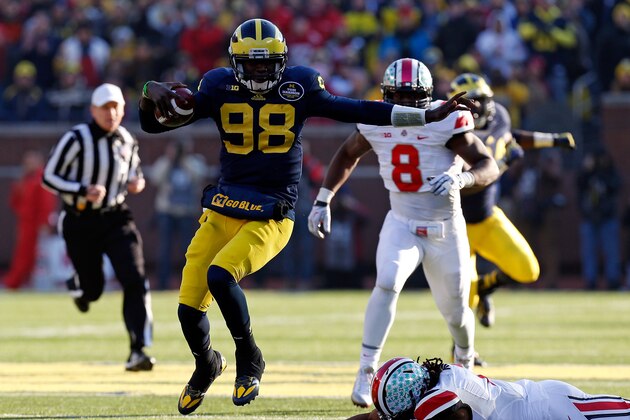 ANN ARBOR, MI - NOVEMBER 30: Quarterback Devin Gardner #98 of the Michigan Wolverines avoids a tackle by cornerback Bradley Roby #1 of the Ohio State Buckeyes during a game at Michigan Stadium on November 30, 2013 in Ann Arbor, Michigan.  (Photo by Gregory Shamus/Getty Images)