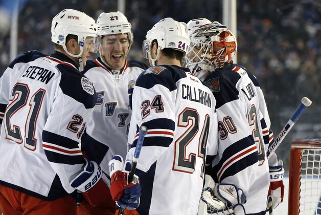 New York Rangers' Derek Stepan (21), Ryan McDonagh (27), Ryan Callahan (24) and goalie Henrik Lundqvist (30), of Sweden, celebrate at the conclusion of an NHL hockey game against the New York Islanders at Yankee Stadium in New York, Wednesday, Jan. 29, 2014. The Rangers defeated the Islanders 2-1. (AP Photo/Kathy Willens)