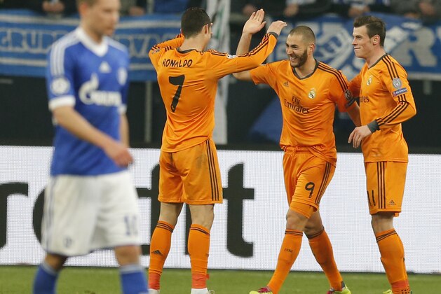 Real's Cristiano Ronaldo, Real's Karim Benzema and Real's Gareth Bale, from left, celebrate their team's fourth goal during the Champions League round of the last 16 first leg soccer match between Schalke 04 and Real Madrid in Gelsenkirchen, Germany, Wednesday, Feb.26,2014. (AP Photo/Frank Augstein)