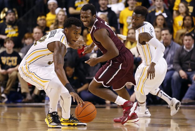 Jan 29, 2014; Richmond, VA, USA; Virginia Commonwealth Rams guard Melvin Johnson (32) steal the ball from Fordham Rams guard Jon Severe (10) in the first half at Stuart C. Siegel Center. The Rams won 76-60. Mandatory Credit: Geoff Burke-USA TODAY Sports