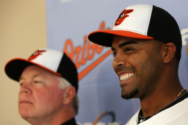 Baltimore Orioles' Nelson Cruz, right, and manager Buck Showalter pose for pictures after Cruz was introduced to the media during a news conference at the Ed Smith Stadium complex before the team's baseball spring training workout in Sarasota, Fla., Tuesday, Feb. 25, 2014. The Orioles signed a one- year deal with Cruz. (AP Photo/Gene J. Puskar) Baltimore Orioles' Nelson Cruz, right, and manager Buck Showalter pose for pictures after Cruz was introduced to the media during a news conference at the Ed Smith Stadium complex before the team's baseball spring training workout in Sarasota, Fla., Tuesday, Feb. 25, 2014. The Orioles signed a one- year deal with Cruz. (AP Photo/Gene J. Puskar)