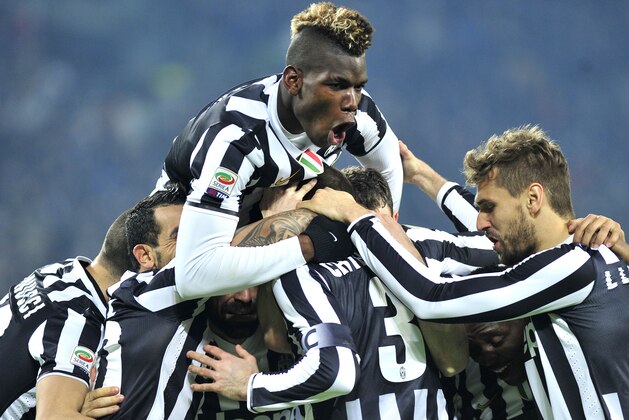 Juventus defender Giorgio Chiellini, back to camera,  celebrates with teammates after scoring  during a Serie A soccer match between Juventus and Inter Milan at the Juventus stadium, in Turin, Italy, Sunday, Feb. 2, 2014. (AP Photo/Massimo Pinca)