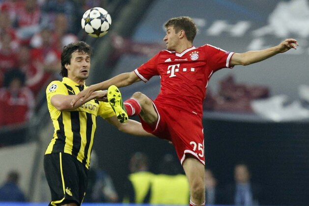 Bayern's Thomas Mueller, left, vies for the ball with Dortmund's Mats Hummels, during the Champions League Final between  Borussia Dortmund and Bayern Munich at Wembley Stadium in London, Saturday May 25, 2013. (AP Photo/Jon Super)