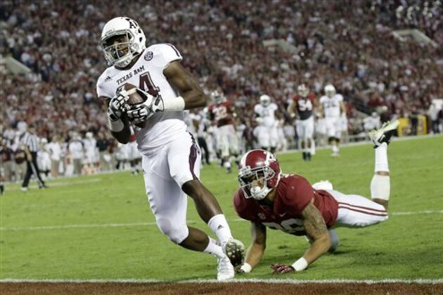 Texas A&M wide receiver Malcome Kennedy (84) catches the game winning touchdown as Alabama defensive back Dee Milliner (28) defends during the second half of an NCAA college football game at Bryant-Denny Stadium in Tuscaloosa, Ala., Saturday, Nov. 10, 2012. (AP Photo/Dave Martin)