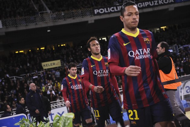 FC Barcelona's Adriano Correia of Brazil, Neymar da Silva of Brazil, and Lionel Messi of Argentina, right to left, arrive at the pitch during their Spanish League soccer match against eal Sociedad, at Anoeta  stadium in San Sebastian, Spain, Saturday, Feb. 22, 2014. (AP Photo/Alvaro Barrientos)