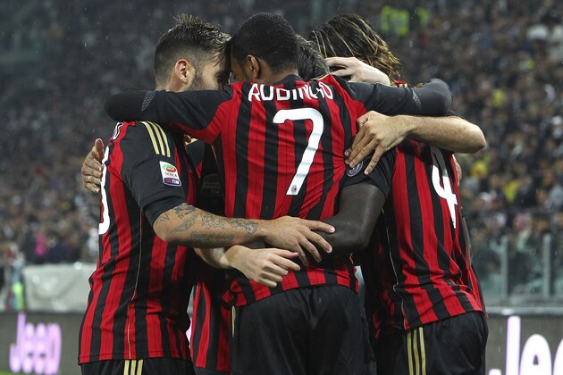 TURIN, ITALY - OCTOBER 06:  Sulley Muntari (R) of AC Milan celebrates with team-mates after scoring the opening goal during the Serie A match between Juventus and AC Milan at Juventus Arena on October 6, 2013 in Turin, Italy.  (Photo by Marco Luzzani/Getty Images)