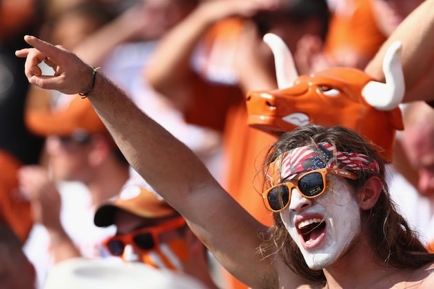 DALLAS, TX - OCTOBER 12:  Texas Longhorns fans celebrate after the Longhorns scored against the Oklahoma Sooners in the third quarter at the Cotton Bowl on October 12, 2013 in Dallas, Texas. The Longhorns beat the Sooners 36-20.  (Photo by Tom Pennington/Getty Images)
