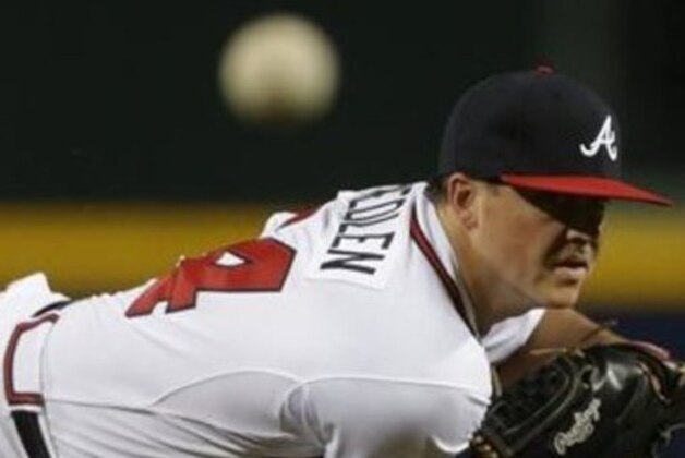 Atlanta Braves starting pitcher Kris Medlen (54) works against the Los Angeles Dodgers during the first inning of Game 1 of the National League Divisional Series, Thursday, Oct. 3, 2013, in Atlanta. (AP Photo/David Goldman)