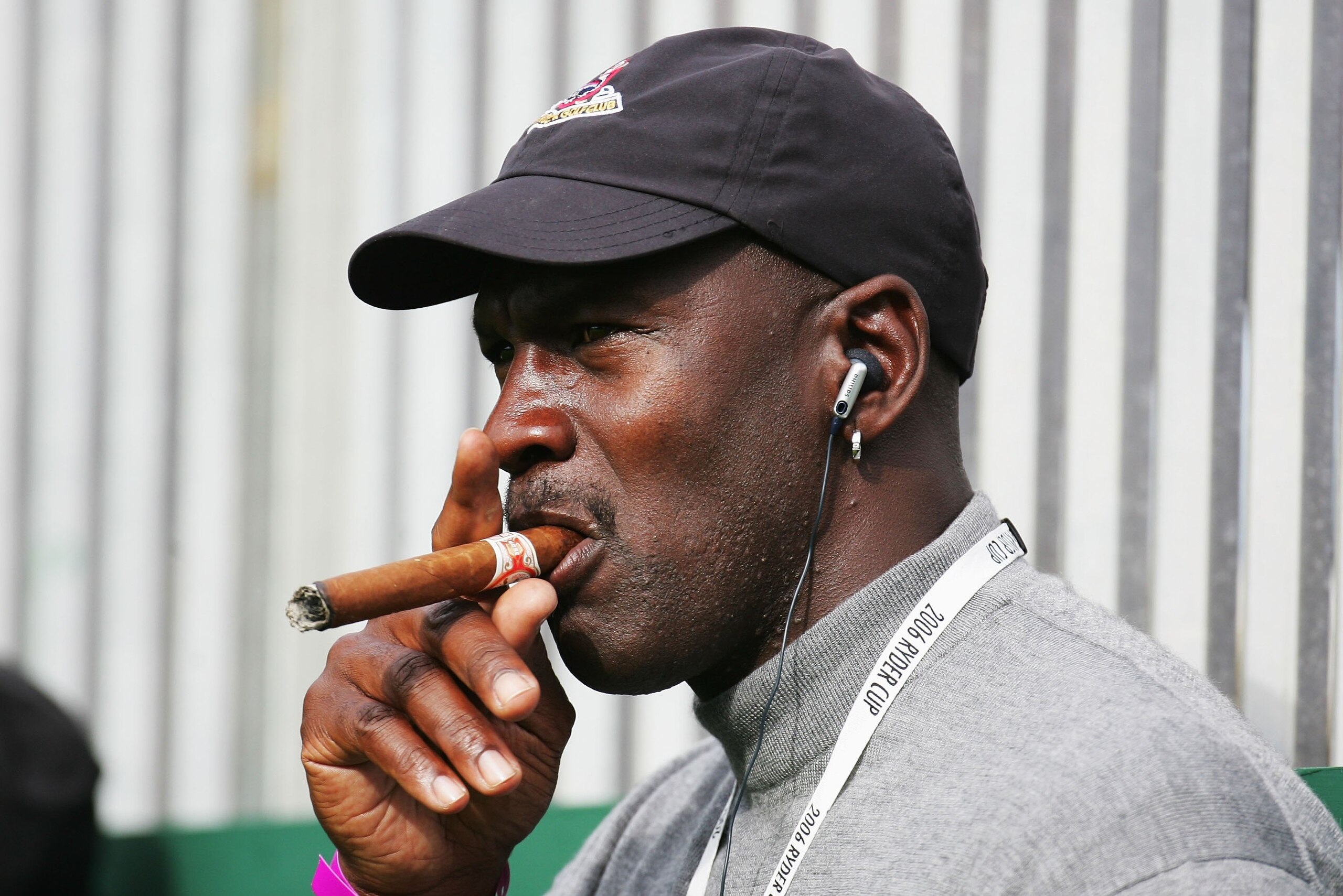 KILDARE, IRELAND - SEPTEMBER 22:  Michael Jordan smokes a cigar and watches the action during the morning fourballs of the first day of the 2006 Ryder Cup at The K Club on September 22, 2006 in Straffan, Co. Kildare, Ireland.  (Photo by Ross Kinnaird/Getty Images)