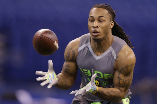 Louisville defensive back Calvin Pryor runs a drill at the NFL football scouting combine in Indianapolis, Tuesday, Feb. 25, 2014. (AP Photo/Michael Conroy)