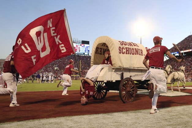 The Oklahoma Sooner Schooner and the Ruf Neks ride out onto the field following an Oklahoma touchdown over TCU during the first half of an NCAA college football game on Saturday, Oct. 5, 2013, in Norman, Okla. Oklahoma won 20-17. (AP Photo/Alonzo Adams)