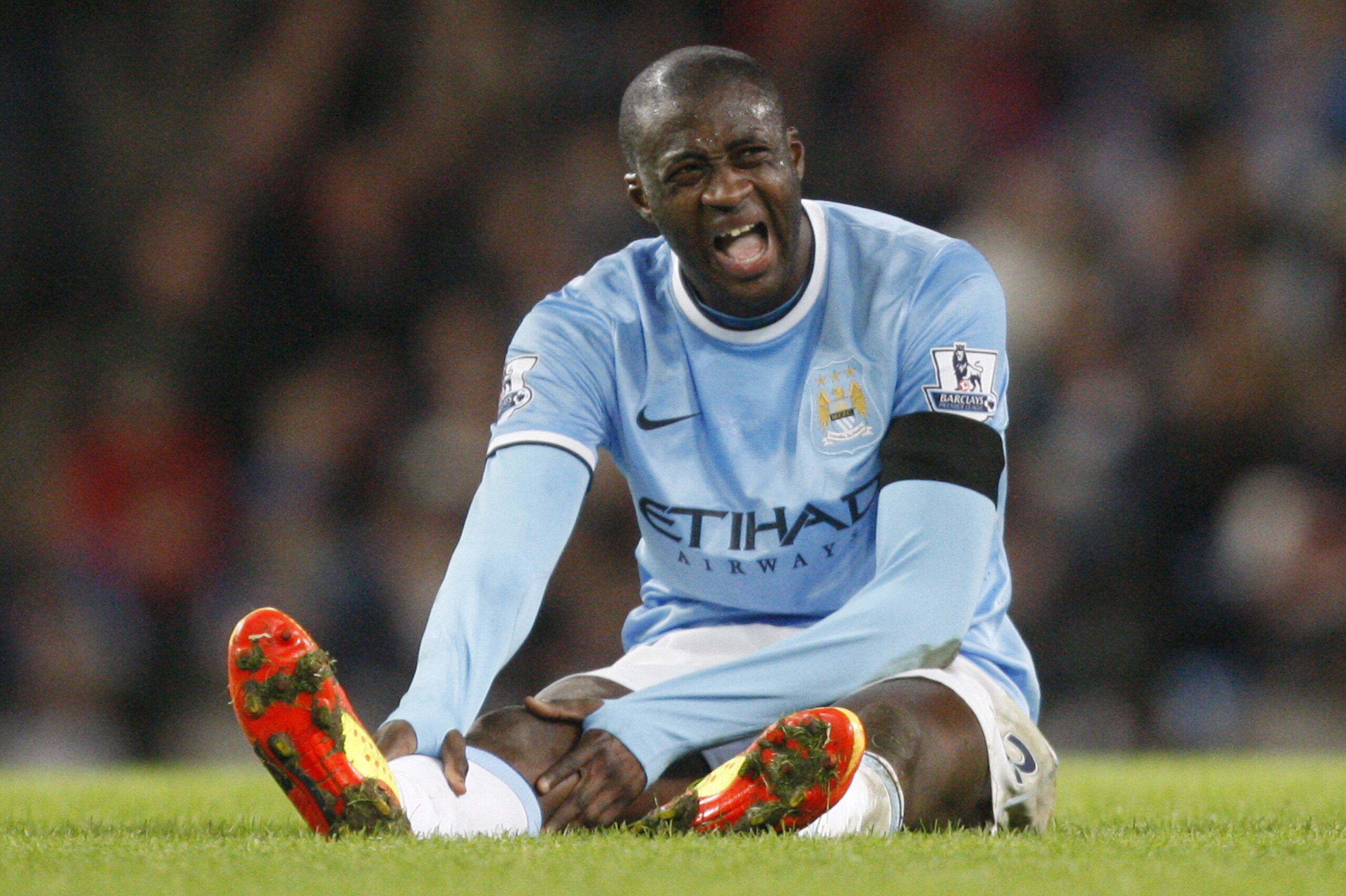 Manchester City's Yaya Toure sits on the ground at the end of their match against Chelsea  in the English FA Cup fifth round soccer game at the Etihad Stadium, Manchester, England, Saturday, Feb. 15, 2014. city won the match 2-0.(AP Photo/Jon Super)