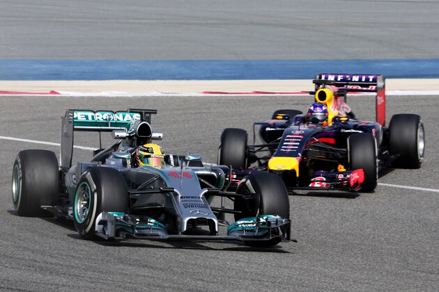 Formula One driver Daniel Ricciardo of Red Bull Racing chases Formula One driver Lewis Hamilton of Mercedes down the track during pre-season testing at the Bahrain International Circuit in Sakhir, Bahrain, on Friday, Feb. 28, 2014. (AP Photo/Hasan Jamali)