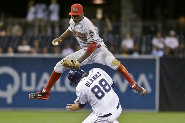 Arizona Diamondbacks shortstop Didi Gregorius hurdles San Diego Padres' Kyle Blanks after getting a force out in the fifth inning of a baseball game Tuesday, Sept. 24, 2013, in San Diego. (AP Photo/Lenny Ignelzi)