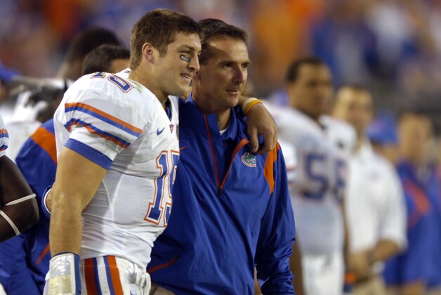 Florida quarterback Tim Tebow, left, head coach Urban Meyer celebrate in the fourth quarter against Georgia during an NCAA college football game, Saturday, Nov. 1, 2008 in Jacksonville, Fla. Florida beat Georgia 49-10.  (AP Photo/Stephen Morton)