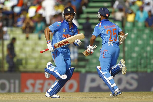India’s Virat Kohli, left, and Shikhar Dhawan run between the wickets during  the Asia Cup one-day international cricket tournament against Sri Lanka in Fatullah, near Dhaka, Bangladesh, Friday, Feb. 28, 2014. (AP Photo/A.M. Ahad)