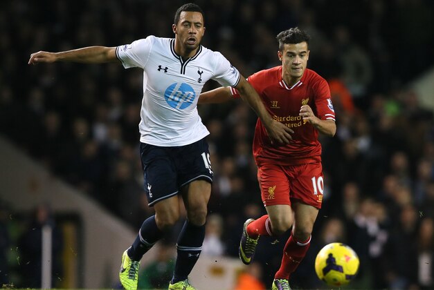 Tottenham's Mousa Dembele, left holds off the challenge of Liverpool's Philippe Coutinho during their English Premier League soccer match between Tottenham Hotspur and Liverpool at the White Hart Lane stadium in London Sunday, Dec. 15, 2013. (AP Photo/Alastair Grant)