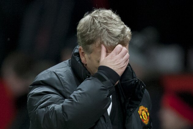 Manchester United's manager David Moyes walks from the pitch after his team's 2-1 loss to Swansea City in their English FA Cup third round soccer match at Old Trafford Stadium, Manchester, England, Sunday, Jan. 5, 2014. (AP Photo/Jon Super)