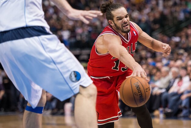 Feb 28, 2014; Dallas, TX, USA; Chicago Bulls center Joakim Noah (13) passes the ball past Dallas Mavericks power forward Dirk Nowitzki (41) during the second half at the American Airlines Center. The Bulls defeated the Mavericks 100-91. Mandatory Credit: Jerome Miron-USA TODAY Sports