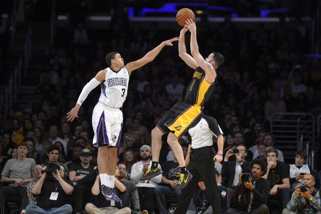 Los Angeles Lakers guard Jordan Farmar, right, puts up a shot as Sacramento Kings guard Ray McCallum defends during the second half of an NBA basketball game, Friday, Feb. 28, 2014, in Los Angeles. (AP Photo/Mark J. Terrill)