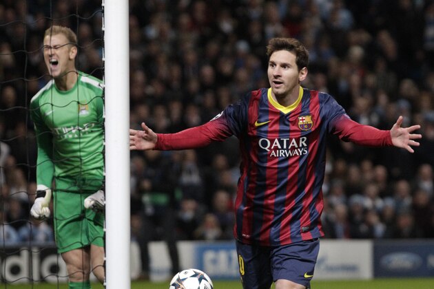 Barcelona's Lionel Messi celebrates after he scores the first goal of the game for his side from a penalty during the Champions League first knock out round soccer match between Barcelona and Manchester City at the Etihad Stadium, Manchester, England, Tuesday Feb. 18, 2014. (AP Photo/Jon Super)