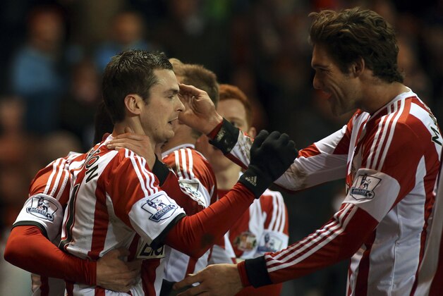 Sunderland's Adam Johnson, left, celebrates his goal with his teammates during their English Premier League soccer match against Stoke City at the Stadium of Light, Sunderland, England, Wednesday, Jan. 29, 2014. (AP Photo/Scott Heppell)