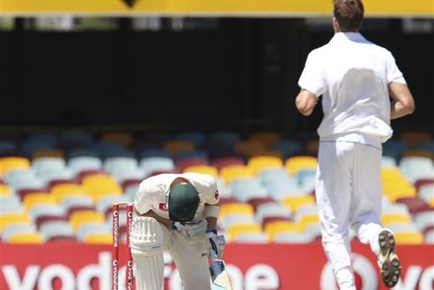 Australia's Michael Clarke reacts after being hit by a ball bowled by South Africa's Morne Morkel, right, during day five of the first cricket test between Australia and South Africa at the Gabba stadium in Brisbane, Australia, Tuesday, Nov. 13, 2012. (AP Photo/Tertius Pickard)
