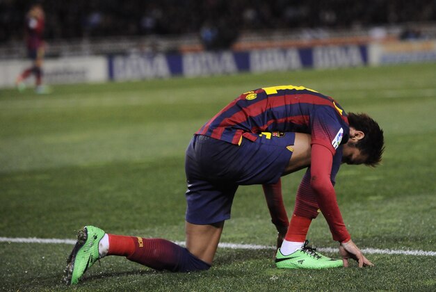 FC Barcelona's Neymar da Silva of Brazil, kneels on the pitch at the end of the match against Real Sociedad, during their Spanish League soccer match, at Anoeta  stadium in San Sebastian, Spain, Saturday, Feb. 22, 2014. FC Barcelona lost the match 3-1. (AP Photo/Alvaro Barrientos)