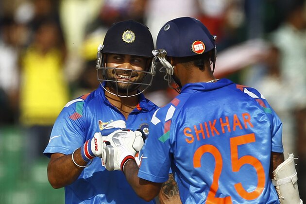 India’s Virat Kohli, left, celebrates with Shikhar Dhawan who scored a boundary during the Asia Cup one-day international cricket tournament against Sri Lanka in Fatullah, near Dhaka, Bangladesh, Friday, Feb. 28, 2014. (AP Photo/A.M. Ahad)