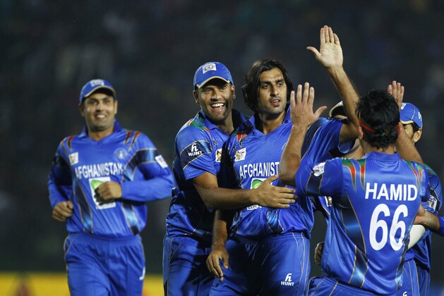 Afghanistan’s Shapoor Zadran, third left, and his teammates celebrate the wicket of Bangladesh’s Shamsur Rahman during the Asia Cup one-day international cricket tournament in Fatullah, near Dhaka, Bangladesh, Saturday, March. 1, 2014. (AP Photo/A.M. Ahad)