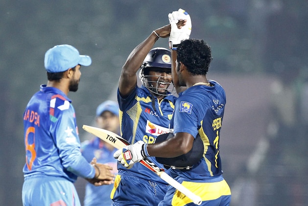 Sri Lanka’s Ajantha Mendis, center, celebrates with Thisara Perera after wining  the Asia Cup one-day international cricket tournament mach against India in Fatullah, near Dhaka, Bangladesh, Friday, Feb. 28, 2014. (AP Photo/A.M. Ahad)