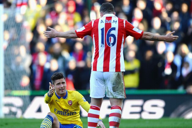 STOKE ON TRENT, ENGLAND - MARCH 01:  Olivier Giroud of Arsenal argues with Charlie Adam of Stoke City during the Barclays Premier League match between Stoke City and Arsenal at Britannia Stadium on March 1, 2014 in Stoke on Trent, England.  (Photo by Laurence Griffiths/Getty Images)