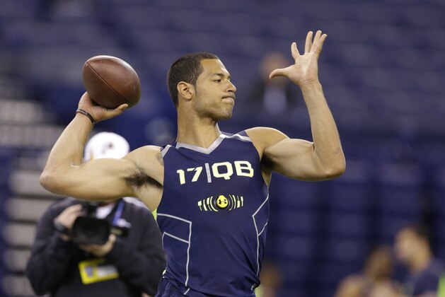 Virginia Tech quarterback Logan Thomas throws during a drill at the NFL football scouting combine in Indianapolis, Sunday, Feb. 23, 2014. (AP Photo/Michael Conroy)