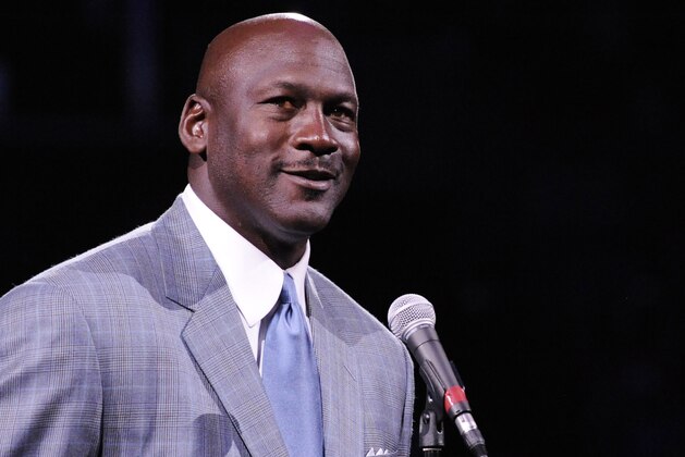 Dec 21, 2013; Charlotte, NC, USA; Charlotte Bobcats owner Michael Jordan unveils the new Charlotte Hornets logo at halftime during the game against the Utah Jazz at Time Warner Cable Arena. Mandatory Credit: Sam Sharpe-USA TODAY Sports