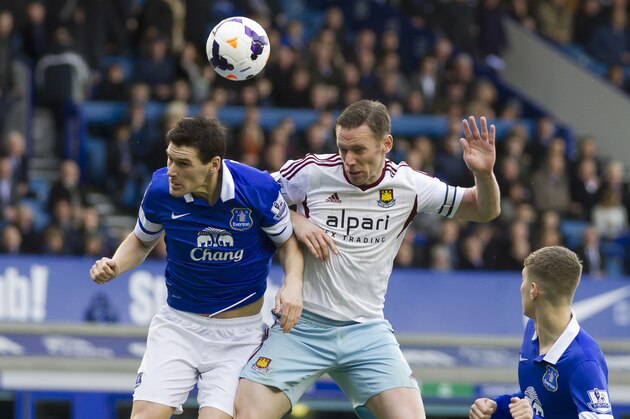 Everton's Gareth Barry, left, fights for the ball against West Ham United's Kevin Nolan during their English Premier League soccer match at Goodison Park Stadium, Liverpool, England, Saturday March 1, 2014. (AP Photo/Jon Super)