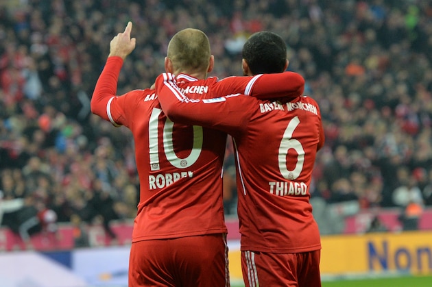 Bayern's Arjen Robben of the Netherlands, left, and Thiago Alcantara of Spain celebrate during the German first division Bundesliga soccer match between FC Bayern Munich and FC Schalke in Munich, Germany, on Saturday, March 1. 2014. (AP Photo/Kerstin Joensson)