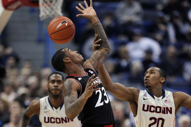 Cincinnati's Sean Kilpatrick (23) and Connecticut's Lasan Kromah (20) fight for a loose ball during the first half of an NCAA college basketball game in Hartford, Conn., Sunday, March 1, 2014. (AP Photo/Fred Beckham) Cincinnati's Sean Kilpatrick (23) and Connecticut's Lasan Kromah (20) fight for a loose ball during the first half of an NCAA college basketball game in Hartford, Conn., Sunday, March 1, 2014. (AP Photo/Fred Beckham)