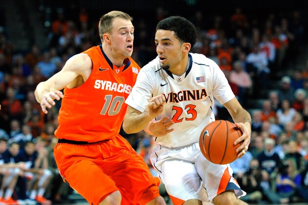 CHARLOTTESVILLE, VA - MARCH 01:  London Perrantes #23 of the Virginia Cavaliers drives to the basket against the defense of Trevor Cooney #10 of the Syracuse Orange during the first half at John Paul Jones Arena on March 1, 2014 in Charlottesville, Virginia.  (Photo by Rich Barnes/Getty Images)